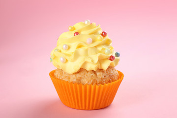 Tasty cupcake on color background