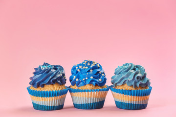 Tasty cupcakes on color background