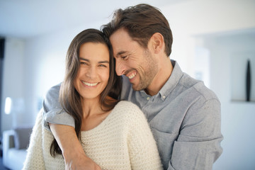Portrait of handsome couple in modern house