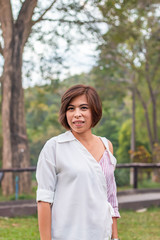 Portrait Asian woman Standing in the grass Background tree