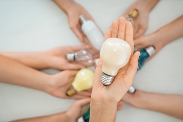 Female hand holding modern light bulb, closeup