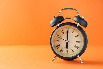 Alarm clock on color background