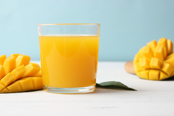 mango juice in a glass and mango fruit.