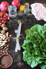 A set of products for a healthy diet. Turkey breast, green salad, nuts