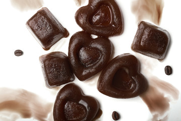 Composition with coffee ice pieces on white background