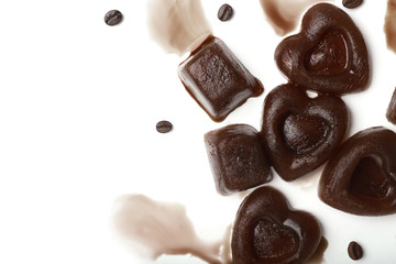 Composition with coffee ice pieces on white background
