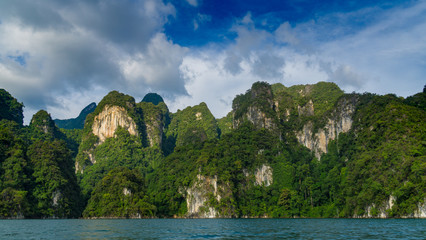Fototapeta premium Panoramic view to landscape with mountains and Cheow lan lake natural attractions in Khao Sok National Park, Surat Thani Province, Thailand.