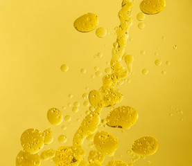 Drops of oil on color background