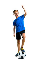 A full-length shot of Lucky boy playing soccer on isolated white background