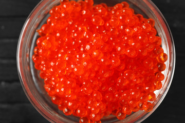 Bowl with delicious red caviar, closeup