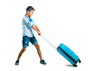 Full body of Boy with sunglasses and headphones traveling with his suitcase on isolated white background