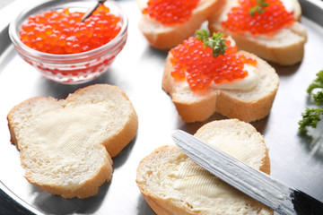 Delicious sandwiches with red caviar on metal tray, closeup