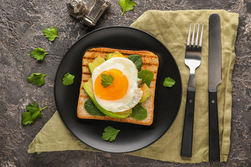 Toasted bread with tasty fried egg on plate