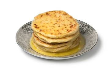 Stack of traditional Moroccan meloui pancakes topped with butter