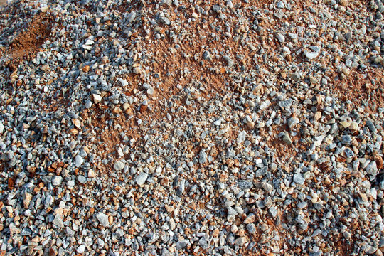 Gravel red dirt road surface texture close up