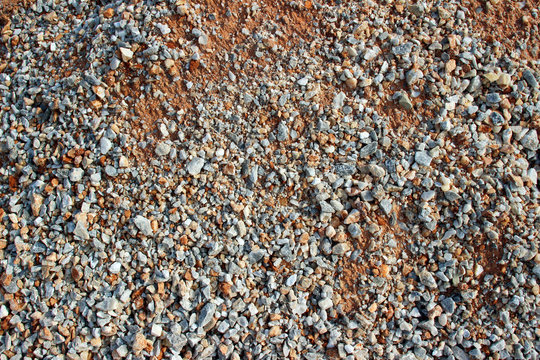 Gravel red dirt road surface texture close up