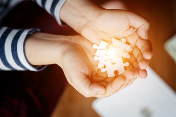 Close Up white connecting jigsaw puzzle in hand