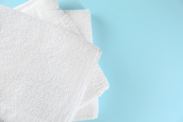 Soft towels on color background