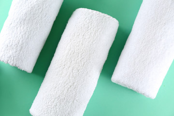 Soft towels on color background