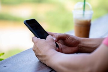 Man's hands using smart phone
