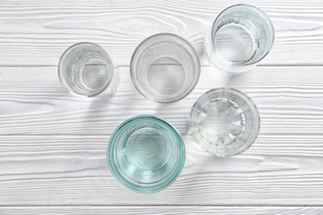 Glasses of fresh water on white wooden table