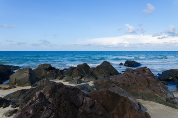 Fototapeta na wymiar Natural tropical beach, blue sky with rock & stone as foreground.