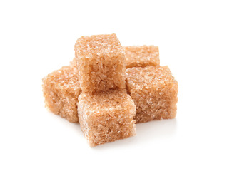 Brown cane sugar cubes on white background