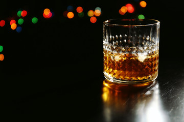 Glass of whiskey on dark background