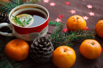 Christmas new year background with tangerines, tea with lemon. winter still. selective focus.