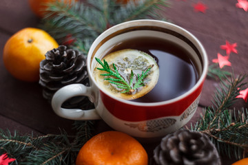Christmas new year background with tangerines, tea with lemon. winter still. selective focus.