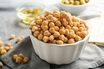 Bowl with fresh chickpeas on table