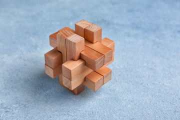 Wooden puzzle on color background