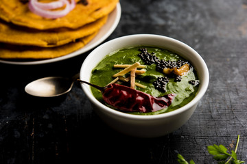 Makki di roti with sarson ka saag, popular punjabi main course recipe in winters made using corn breads mustard leaves curry. served over moody background. selective focus - obrazy, fototapety, plakaty