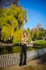 Photographing a girl during autumn with a blurred background