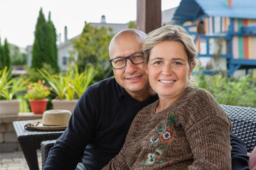 Bold man and woman with short haircut on terrace