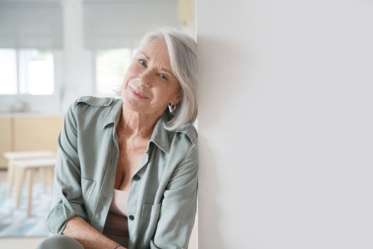  Beautiful relaxed elderly woman sitting at home