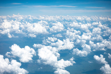 Beautiful bright clear blue sky with tiny cloud out of the airplane for background. Nature weather over the sky and cloud.