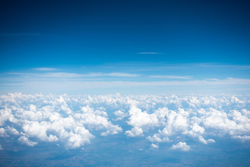 Fototapeta na wymiar Beautiful bright clear blue sky with tiny cloud out of the airplane for background. Nature weather over the sky and cloud.