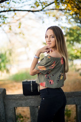 Photographing a girl during autumn with a blurred background