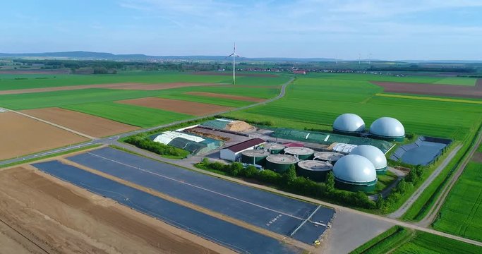 Aerial video of Biogas plant. Flight over Biogas power plants, The agricultural and greenhouse complex is equipped with its own biogas for the production of biogas, Europe