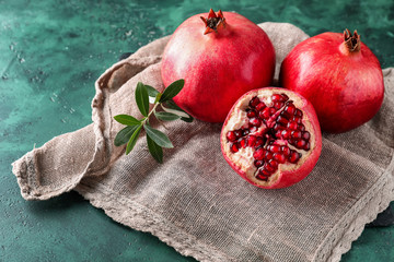 Ripe pomegranates on color background