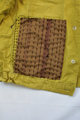 Khaki vintage jacket with patchwork decor sashiko detail, on a white background