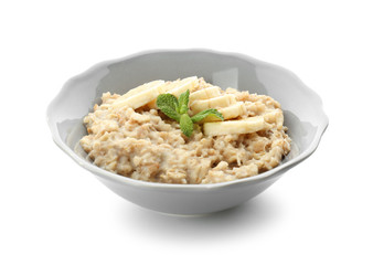 Plate with tasty oatmeal and banana slices on white background