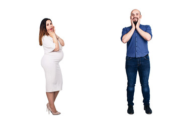 Surprised faces of a young couple on a white background. The pregnant woman and bearded man.