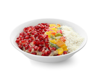 Plate with tasty oatmeal, pomegranate seeds and succades on white background