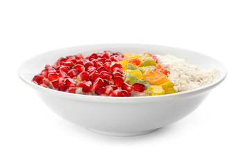 Plate with tasty oatmeal, pomegranate seeds and succades on white background