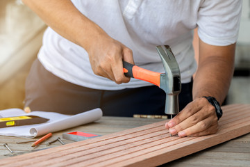 Carpenter man hammering a nail