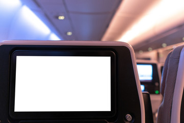 Empty white mock-up of aircraft multimedia screen.Close up view of blank LCD airplane monitor in passenger seat isolated on white background.Copy space ready to use for advertisement design.