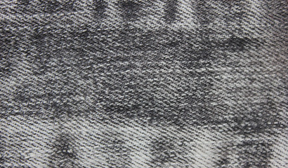 Dark Jeans Texture Background of White and Black Denim Jean Fabric. Close Up Top View of Washed Out Rough Jean Fabric Backdrop, Empty Canvas to Use as Copy Space, Template, Layout, Mock Up or Banner