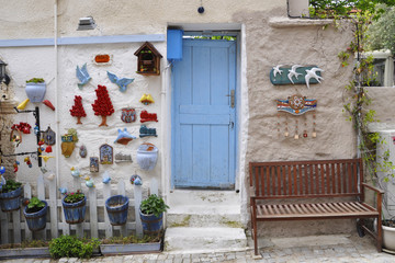 Fototapeta na wymiar Alacati houses, ornamented wall, blue door. Izmir, Turkey.